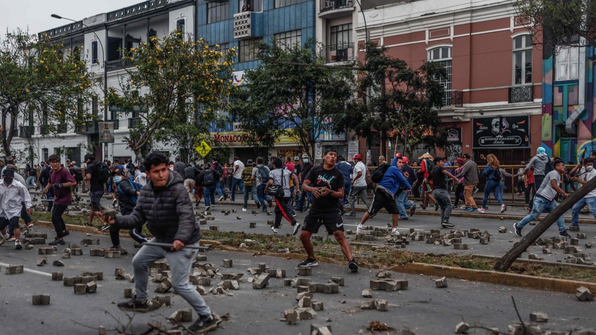 Manifestantes que respaldan al Pedro Castillo se enfrentan a la Policía, a las afueras de la Prefectura de Lima, donde permanece detenido el ahora expresidente, . EFE/  