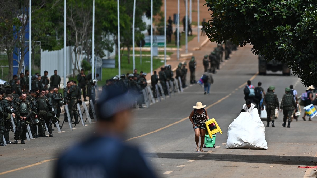 Seguidores del expresidente Jair Bolsonaro salen de las tiendas de campaña en un campamento, hoy lunes 9 de enero, frente al Cuartel General del Ejército, en Brasília (Brasil).