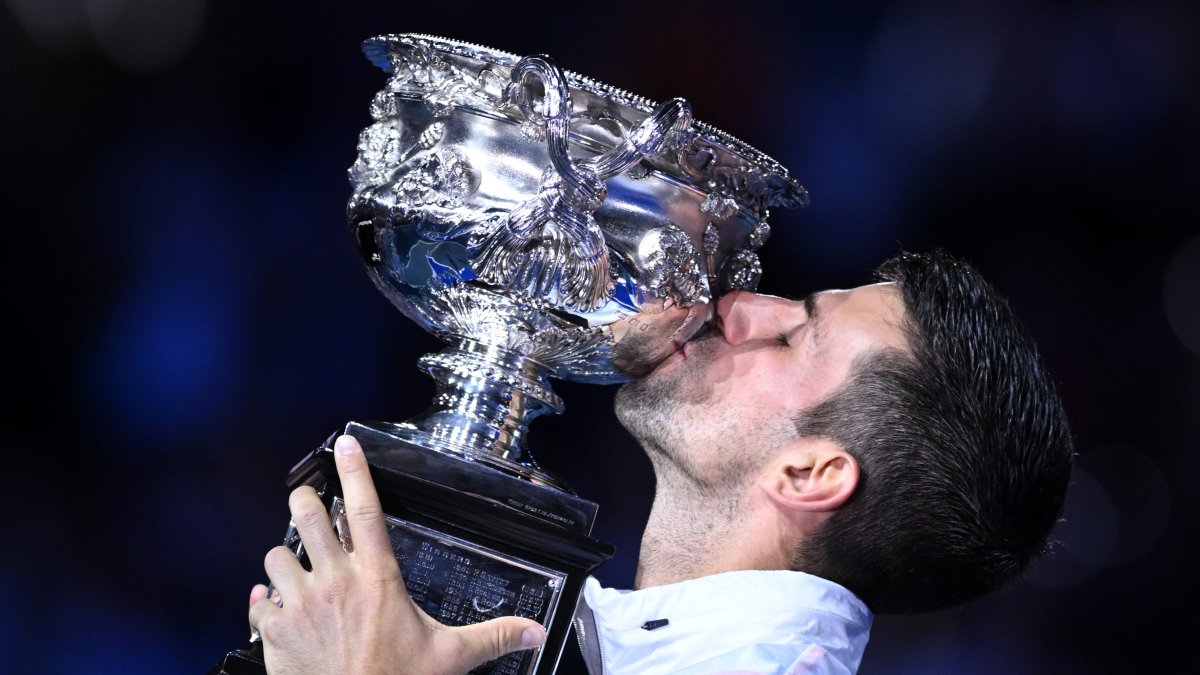 Novak Djokovic, campeón del Abierto de Australia, besa el trofeo ganado este domingo 29 de enero.