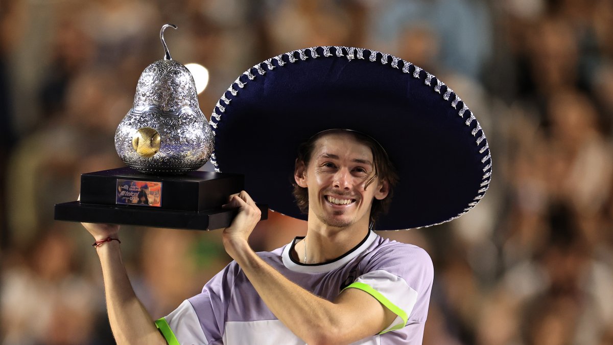 El tenista australiano Alex De Minaur, celebra con el trofeo de campeón al derrotar al estadounidense Tommy Paul.