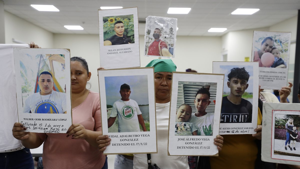 Familiares de personas detenidas bajo el régimen de excepción muestran sus fotografías durante una conferencia de prensa, hoy 10 de marzo , en San Salvador (El Salvador).