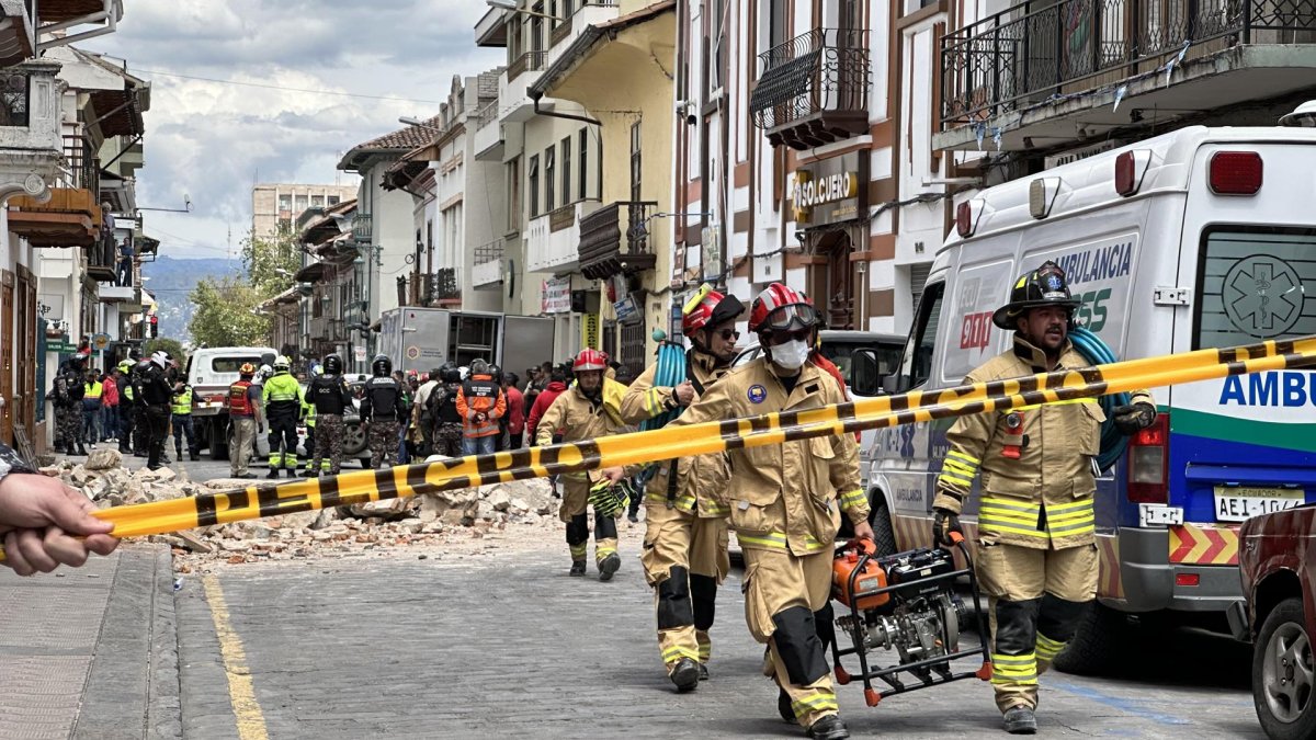 Miembros de los bomberos ayudan con los daños ocasionados por el sismo de magnitud 6,5 en la escala abierta de Richter hoy, en la ciudad de Cuenca (Ecuador).