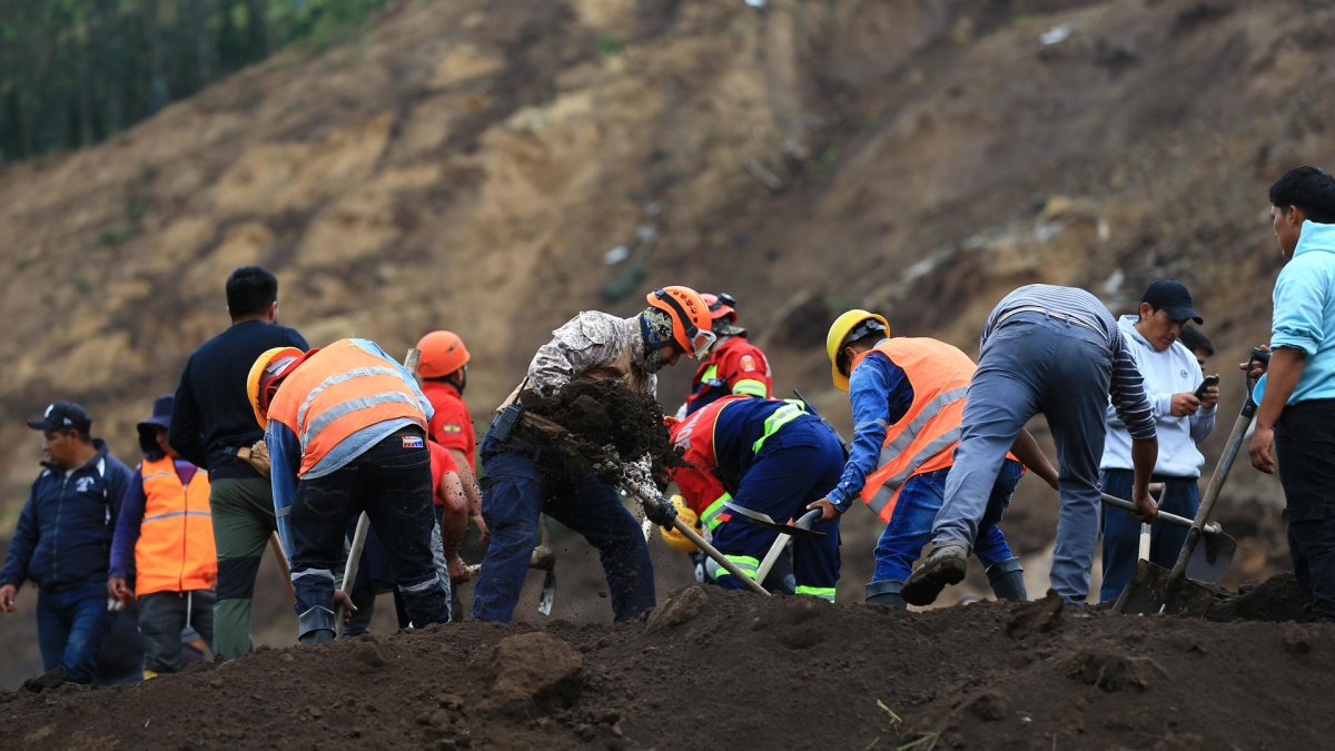 Pobladores y rescatistas buscan a víctimas de un alud hoy, en Alausí (Ecuador).