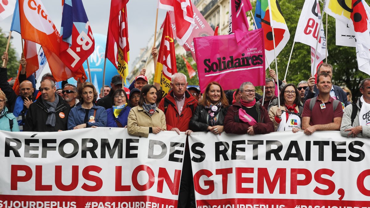 Los principales líderes sindicales franceses llevan una pancarta que dice 