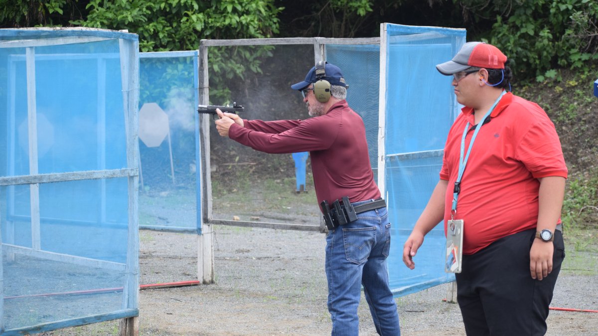 Danilo Soriano practica su puntería, ante la mirada del juez Víctor Mosquera, en el Club Guayas de Tiro y Aviación.