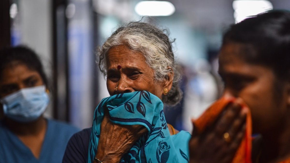 Una mujer busca a su hijo, herido en el accidente, entre los viajeros de un tren especial que ha trasladado a viajeros de los trenes siniestrados a la ciudad india de Chennai.