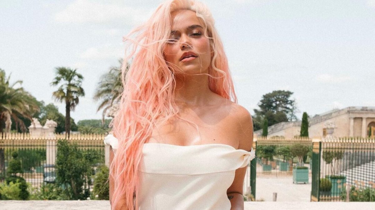 La artista lució un vestido blanco combinado con una mini cartera roja de Jacquemus que cuestan más de 1,300 dólares.