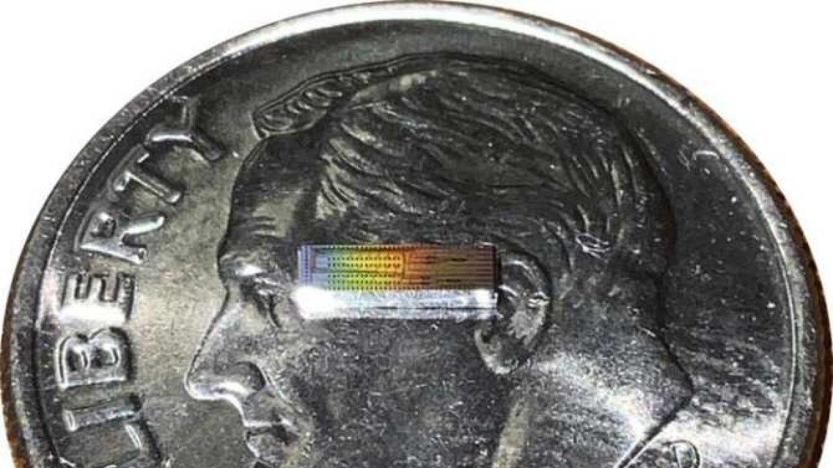 El nuevo chip, pese al trabajo que realiza, es pequeño, como puede verse en esta fotografía en la que aparece encima de una moneda.
