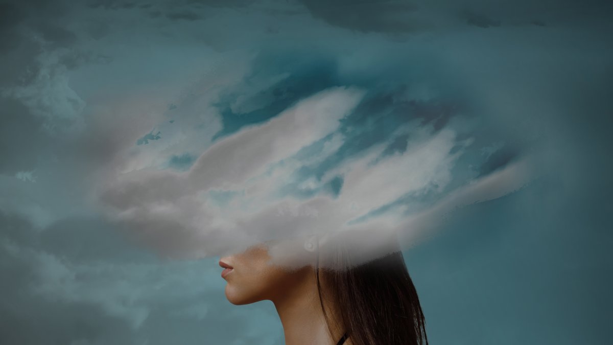 Woman head hidden by soft cloud on blue background, mental health, brain fog