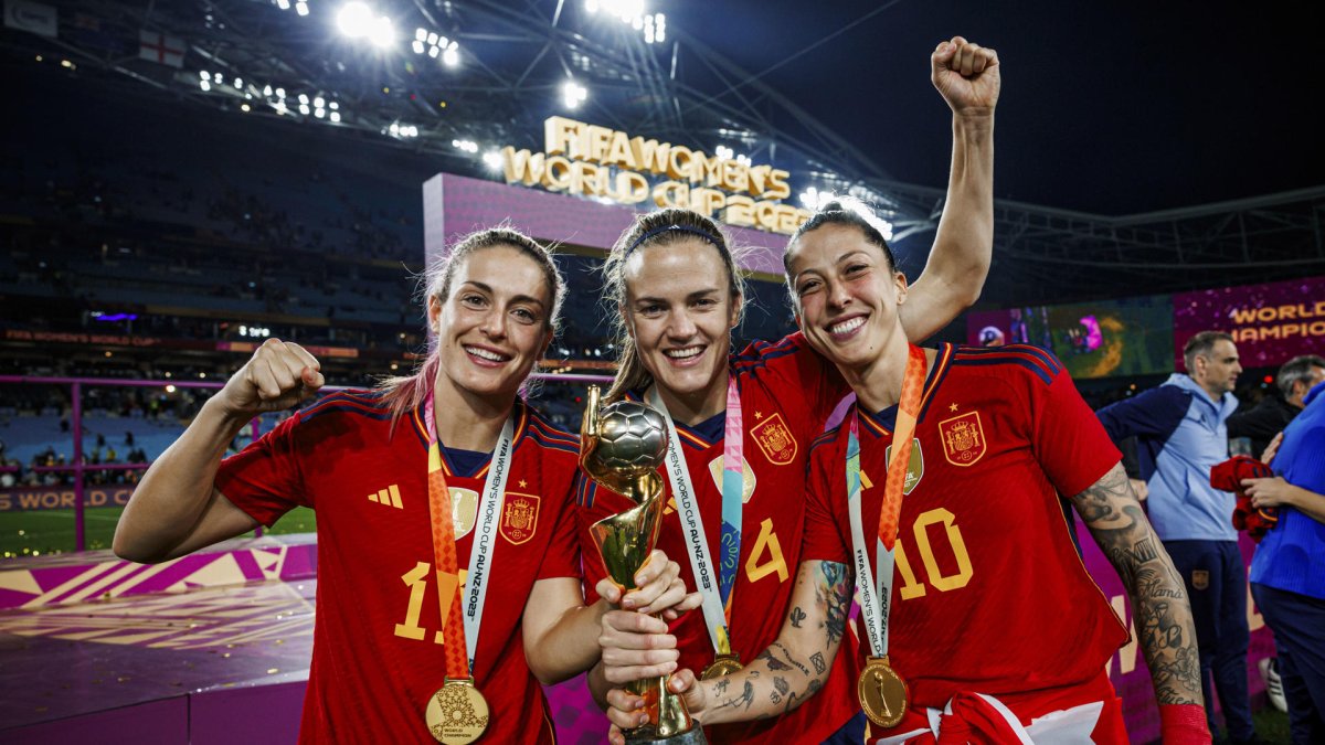 Las jugadoras de la selección española de fútbol femenino Alexia Putellas (i), Irene Parades (c) y Jenni Hermoso posan con el trofeo del Campeonato del Mundo.