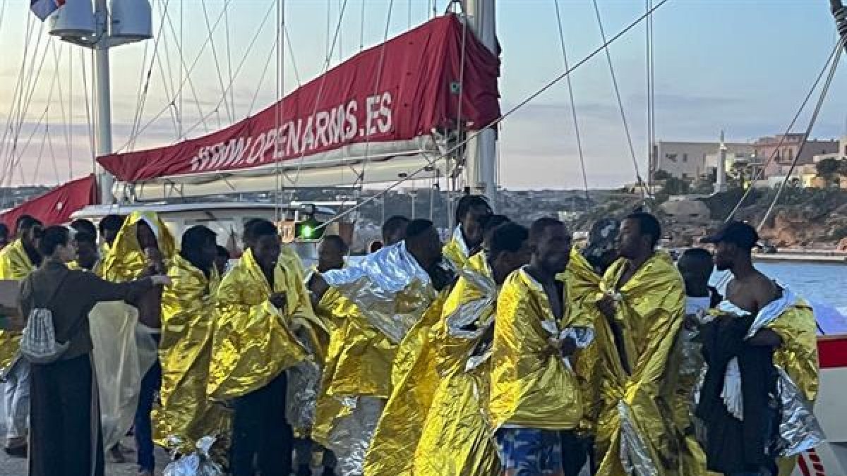 Migrantes rescatados en el Mediterráneo central llegan al puerto italiano de Lampedusa.