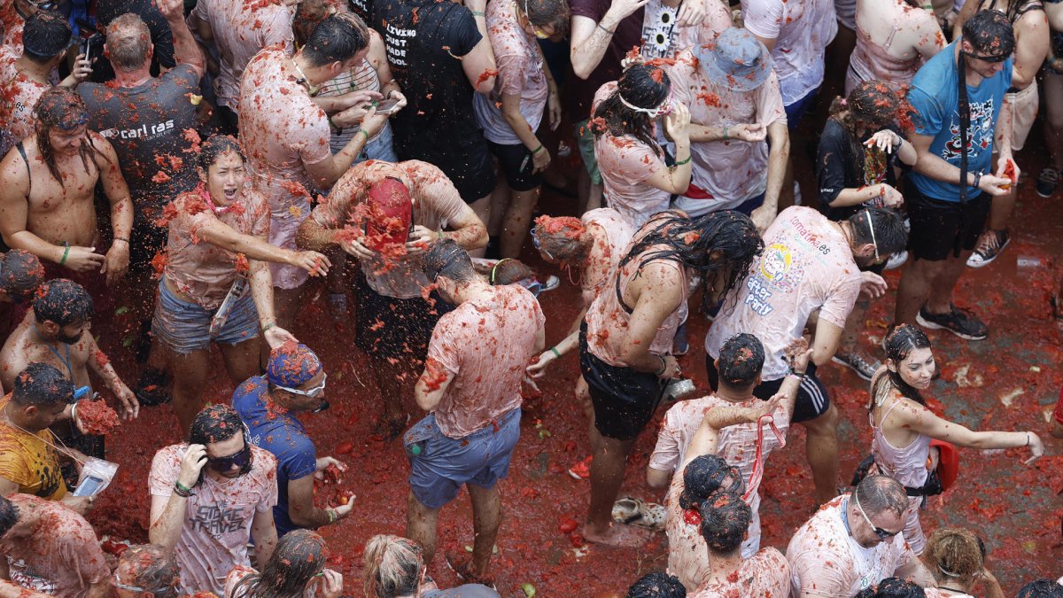 Buñol, en Valencia, volvió un año más a teñirse de rojo con los 120.000 kilos de tomates.