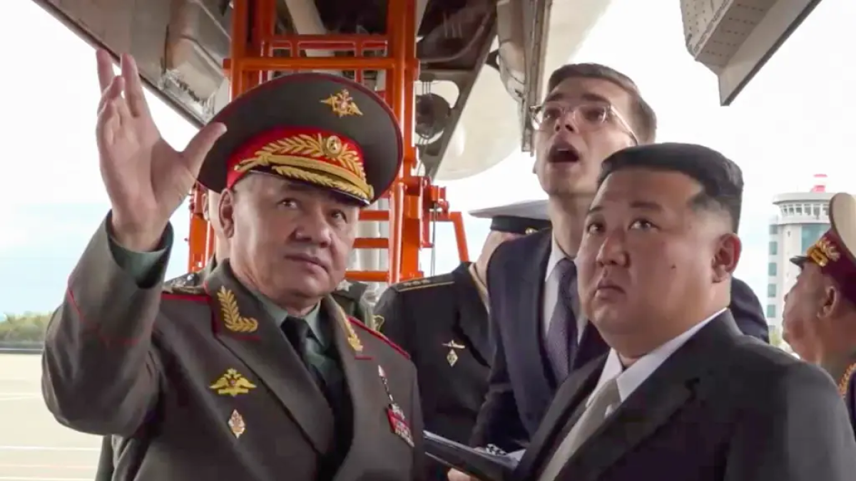 , Kim Jong-un (d), y al ministro de Defensa ruso, Serguéi Shoigú (i), inspeccionando aviones militares rusos en el aeródromo de Knevichi, cerca de Vladivostok