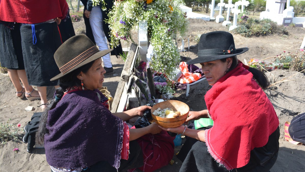 Tradición. Una familia salasaca llevó comida para compartir entre sus miembros, en el cementerio de Pelileo.