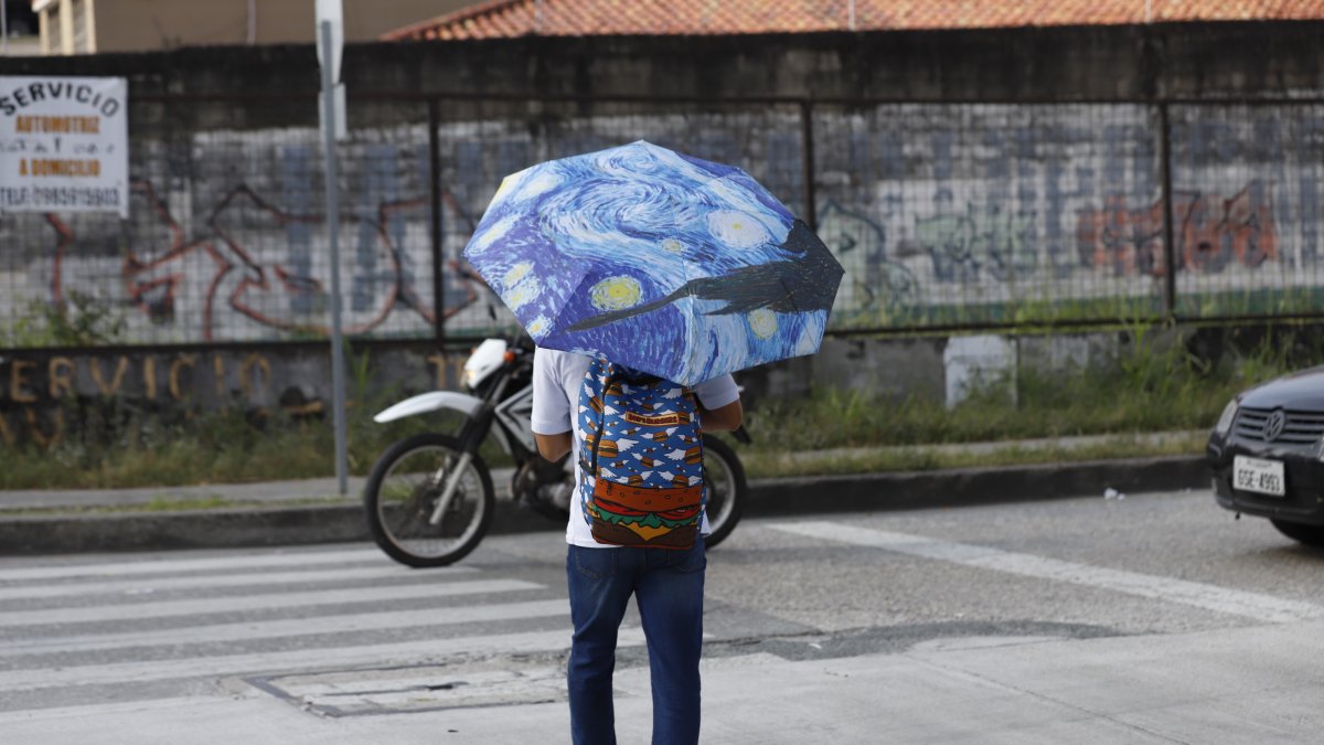 Sol. Un joven usa sombrilla en un día soleado, en el centro de Guayaquil.