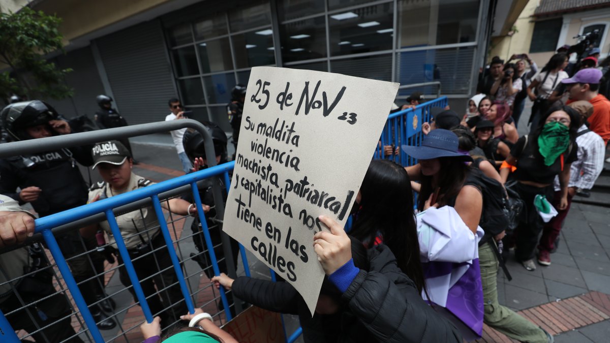 Varias personas se enfrentan con policías antidisturbios durante una marcha con motivo del Día Internacional de la Eliminación de la Violencia Contra la Mujer en Quito