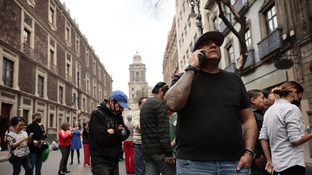 Personas permanecen fuera de sus hogares después de escuchar la alerta sísmica hoy, en la Ciudad de México (México).