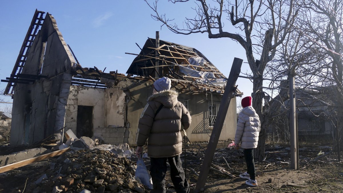 Los lugareños inspeccionan edificios dañados en el lugar de un ataque nocturno con drones en Odesa, sur de Ucrania, el 17 de diciembre de 2023, en medio de la invasión rusa.