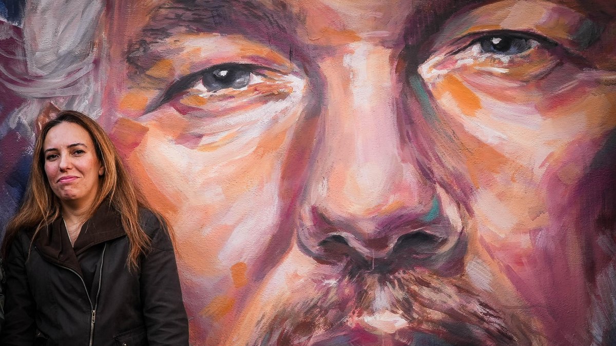 Stella Moris, esposa del periodista australiano fundador de WikiLeaks, Julian Assange, ante un mural con la cara de su esposo