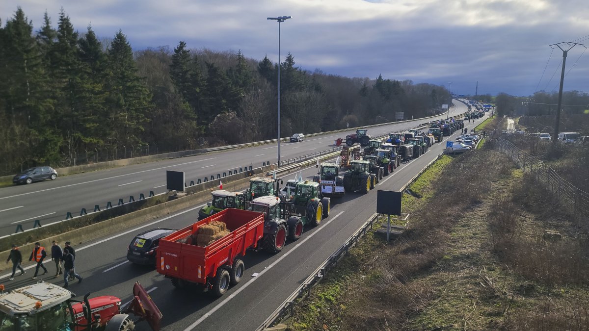 Agricultores franceses llevan a cabo una protesta en la autopista A1, a la altura de Chennevières-lès-Louvres, muy cerca del aeropuerto internacional Charles de Gaulle, este martes.