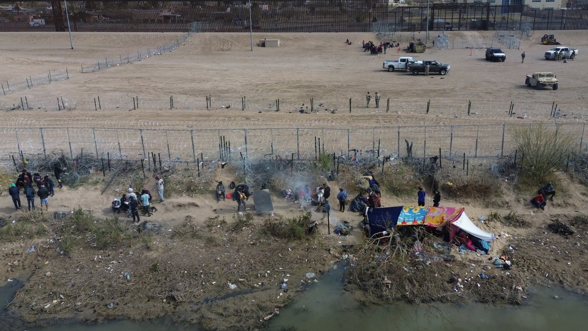 Varios migrantes aparecen en las inmediaciones del Río Bravo, junto al alambrado que divide a México con Estados Unidos, este miércoles, en Ciudad Juárez (México).