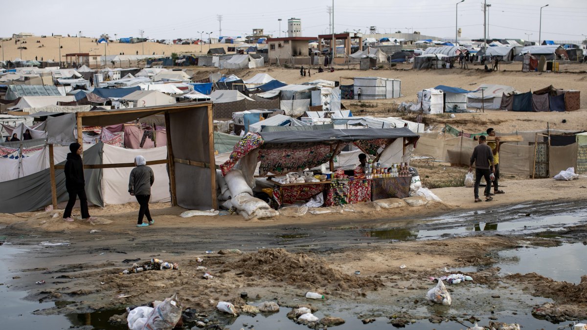 Rafah. Palestinos caminan junto a un derrame de aguas residuales.