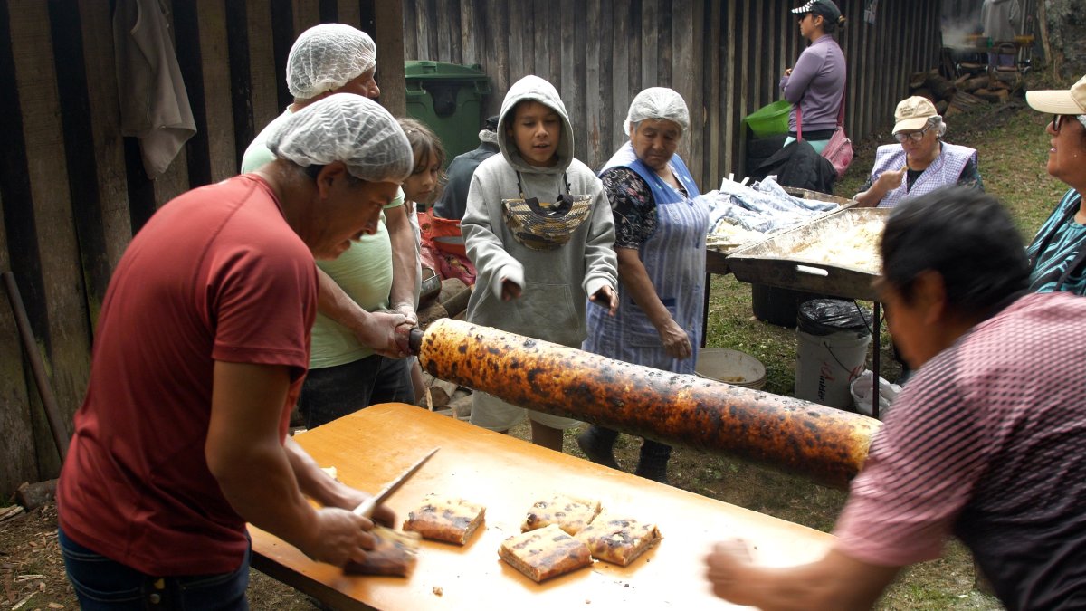 Pobladores preparan la 'chochoca', comida tradicional de Chiloé en base a una masa de papa,