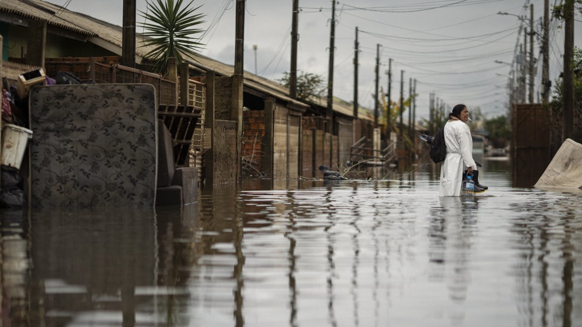 La enfermera, Itajane Barbosa dos Santos, residente del barrio Sarandí, camina por una calle afectada por las inundaciones, este lunes en Porto Alegre.