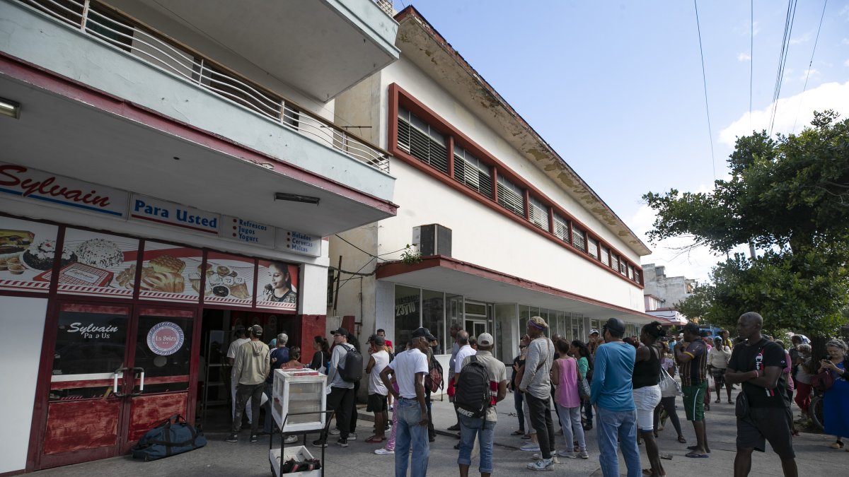 Personas esperan su turno para comparar pan este domingo, en La Habana.