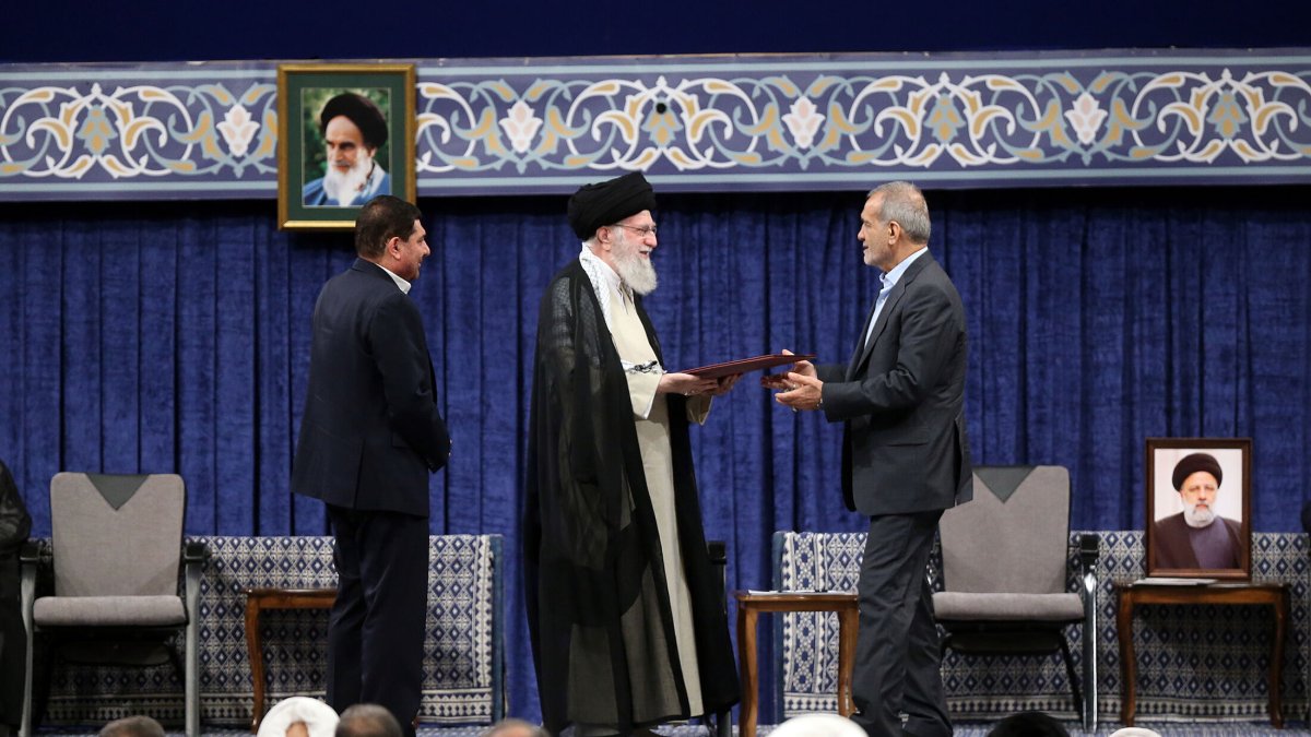 El líder supremo iraní, Ali Jameneí, presenta la carta de respaldo oficial al presidente electo Masud Pezeshkian, en la ceremonia de ratificación en Teherán, el 28 de julio de 2024.
