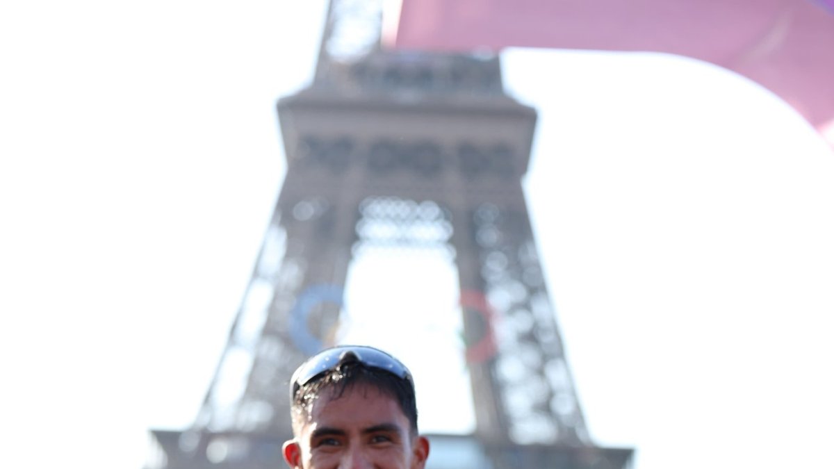 El marchista ecuatoriano no perdió la oportunidad de mostrar la foto de sus hijos Nico y Monse, tras ganar la medalla de oro al pie de la Torre Eiffel.