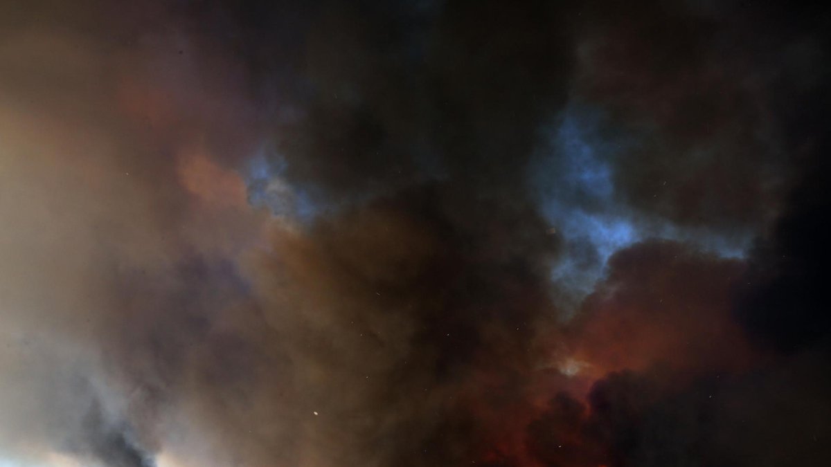 Un humo espeso se eleva durante un incendio forestal que estalló en una zona de tierras de cultivo y bosques en Varnavas, región de Ática, Grecia, el 11 de agosto de 2024.