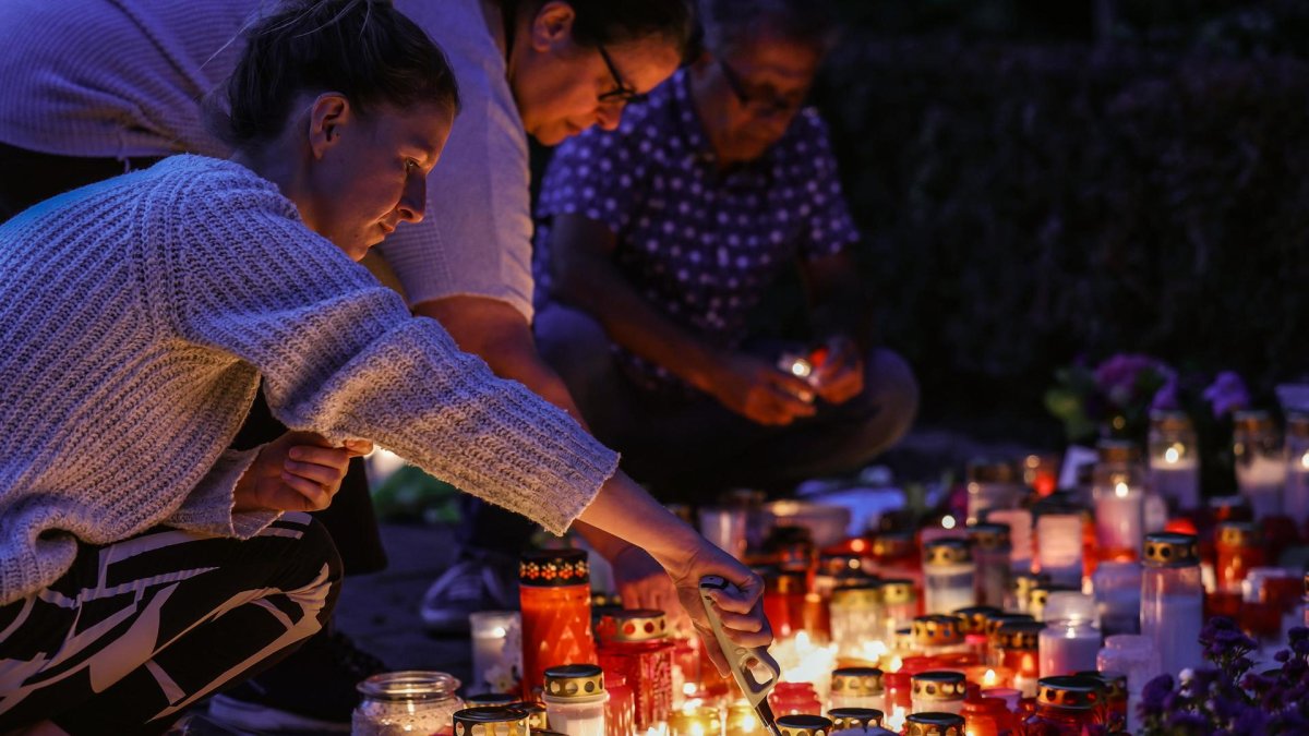 Personas encienden velas cerca de la escena del crimen en Solingen, Alemania, este lunes 26 de agosto del 2024.