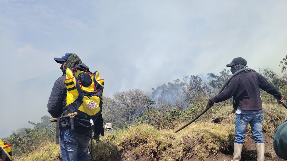 Habitantes de Quinticusig ayudan en la lucha contra el incendio forestal para evitar que lleguen a las fuentes de agua.