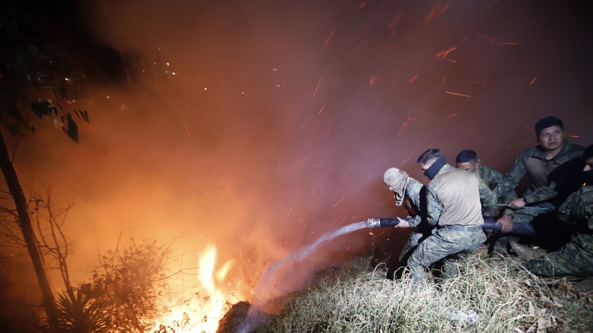 Personal de las Fuerzas Armadas trabaja para sofocar un incendio.