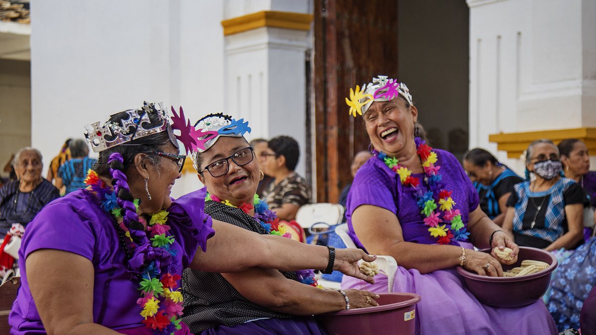 Mujeres indígenas que desgranan mazorcas en la comunidad de Tehuantepec.