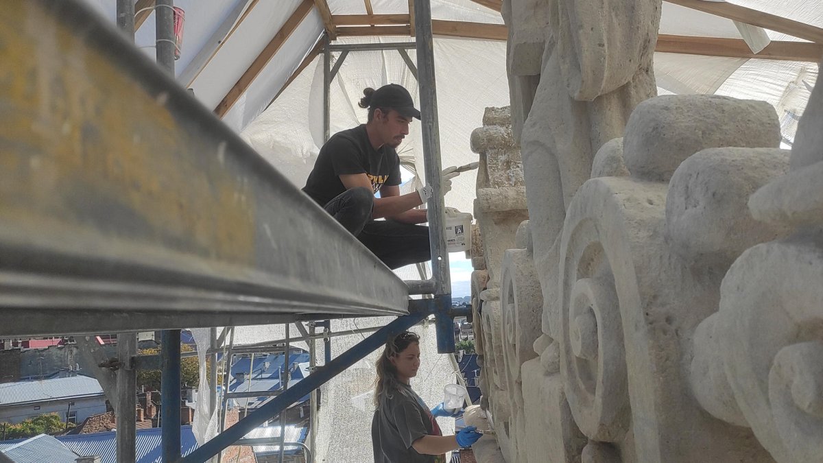 La restauradora Olena Savchuk (abajo) trabaja en la restauración de la torre del antiguo monasterio benedictino del siglo XVII en Leópolis.