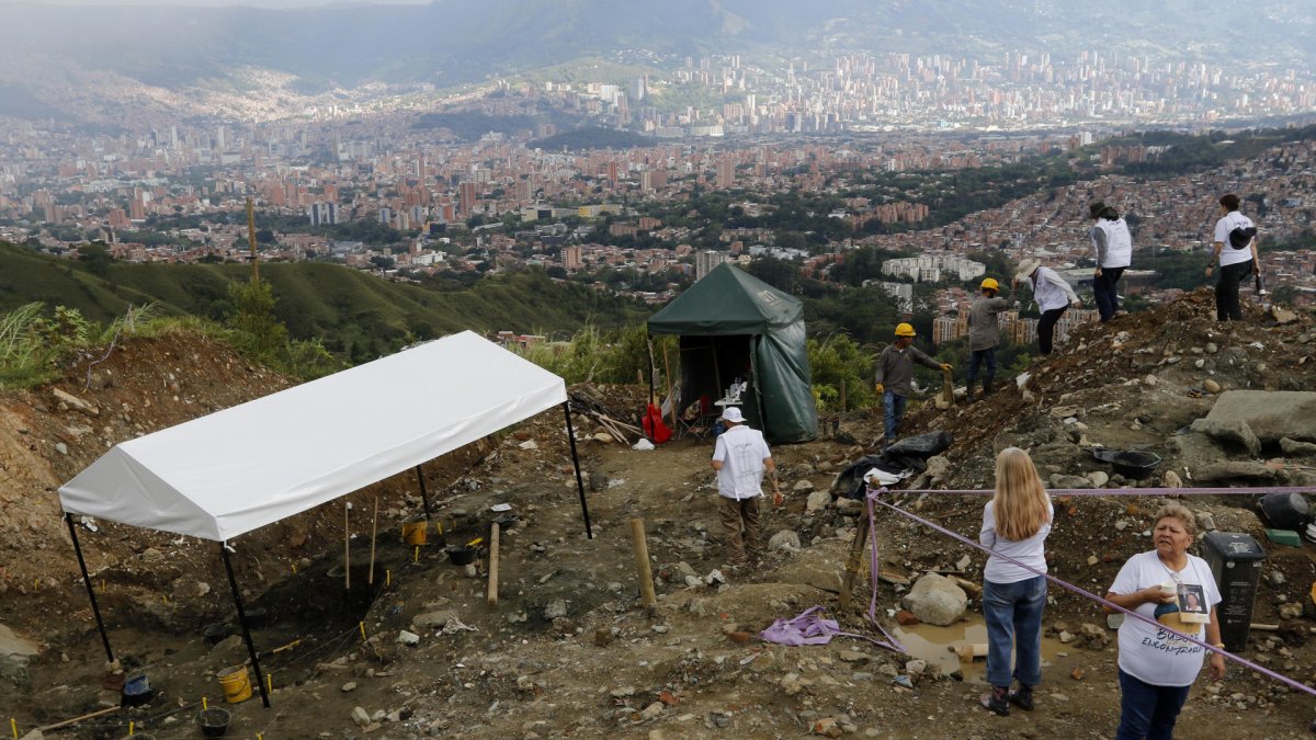 Integrantes de la Unidad de Búsqueda de Personas dadas por Desaparecidas (UBPD) participan este 26 de diciembre de 2024 de una intervención forense en 'La Escombrera', en Medellín.
