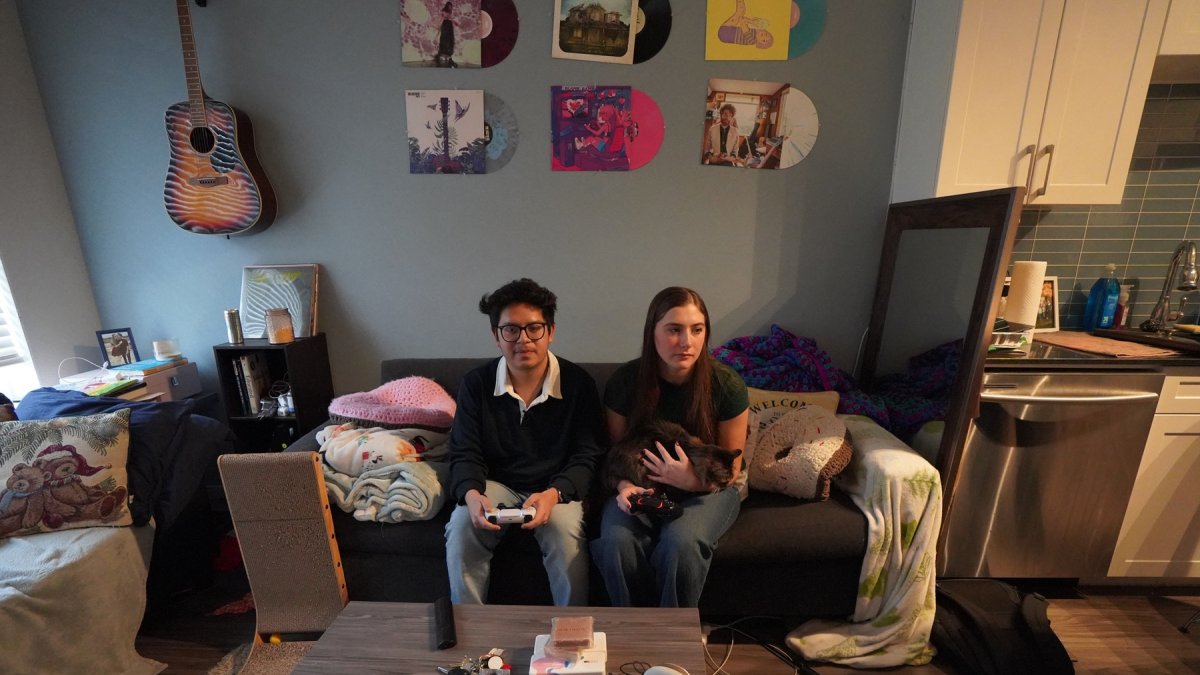 Oscar Silva (24) y Natalie Taylor (23) en su apartamento, en Denton, Texas. Oscar tiene un blanco en la espalda mientras Donald Trump se prepara para retomar el poder.