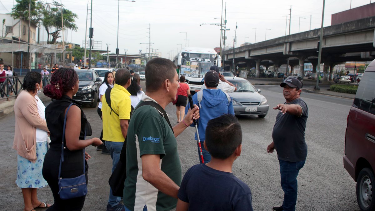 Una persona no vidente es ayudada por los usuarios en plena calzada para lograr subirse a un bus. Escenas como esta se registran a diario.