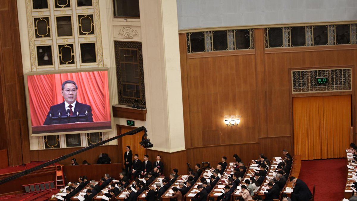 El primer ministro Li Qiang, es visto en una pantalla mientras pronuncia discurso durante la ceremonia de apertura de la Tercera Sesión del 14º Congreso Nacional, en el Gran Salón del Pueblo en Pekín.