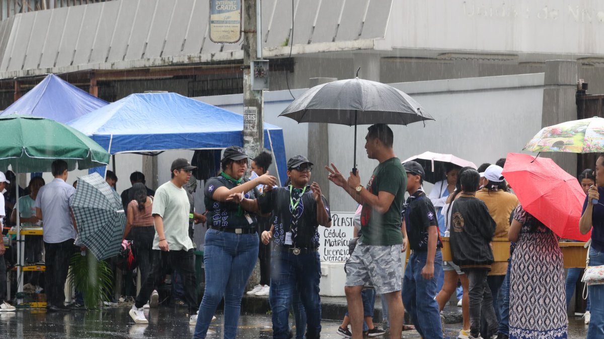 Los niños abordan a los votantes al salir del recinto electoral