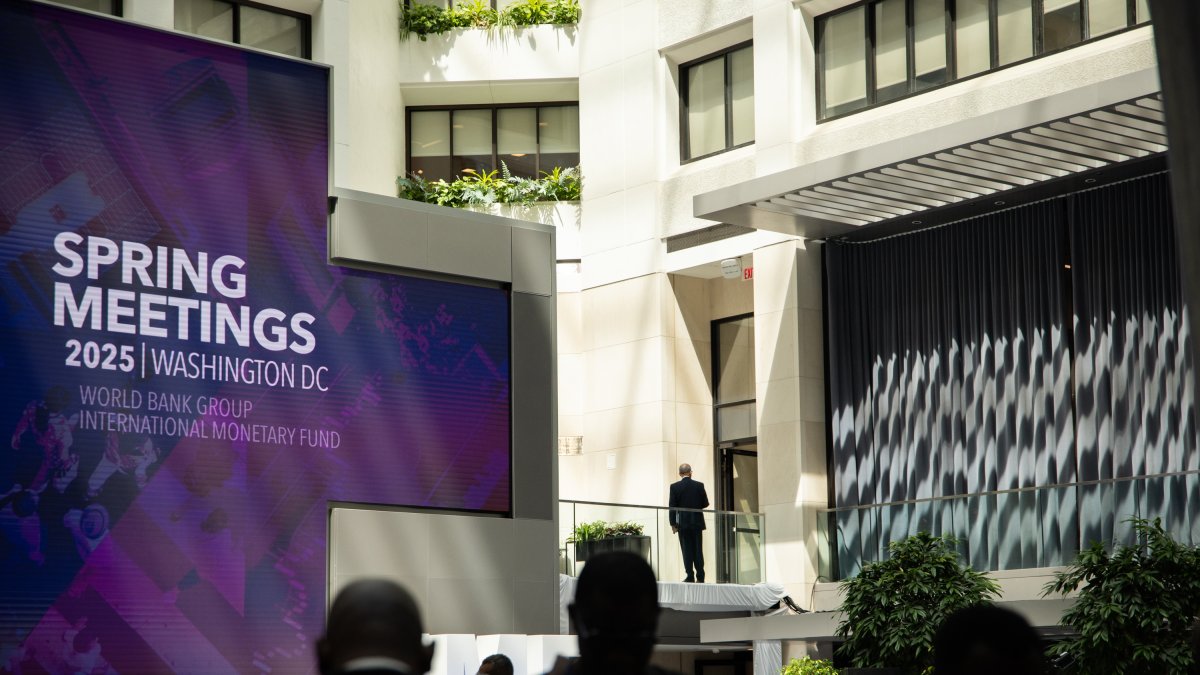 Visitantes y personal asisten a las reuniones de primavera del FMI y el Banco Mundial de 2025, en la sede del FMI en Washington.