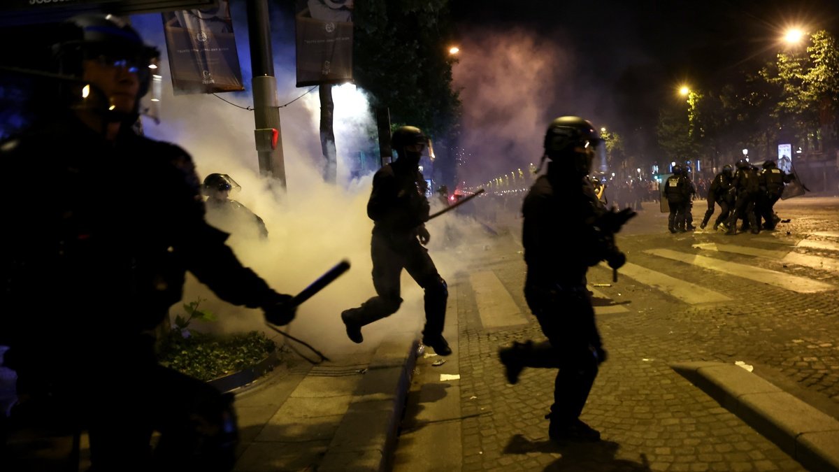 Integrantes de la policía francesa se enfrentan con seguidores del Paris Saint-Germain durante disturbios después de que el PSG ganara la Liga de Campeones frente al Inter de Milán.