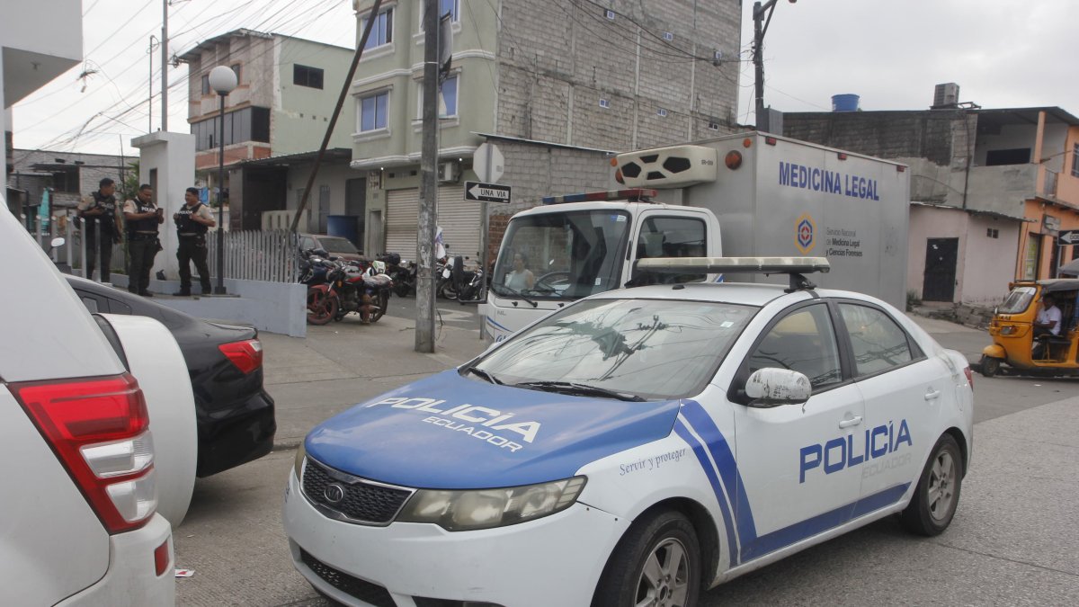 Agentes policiales luego de las pericias por el hallazgo de los cuerpos de cuatro comerciantes en Nueva Prosperina, en el noroeste de Guayaquil, este viernes 6 de junio.