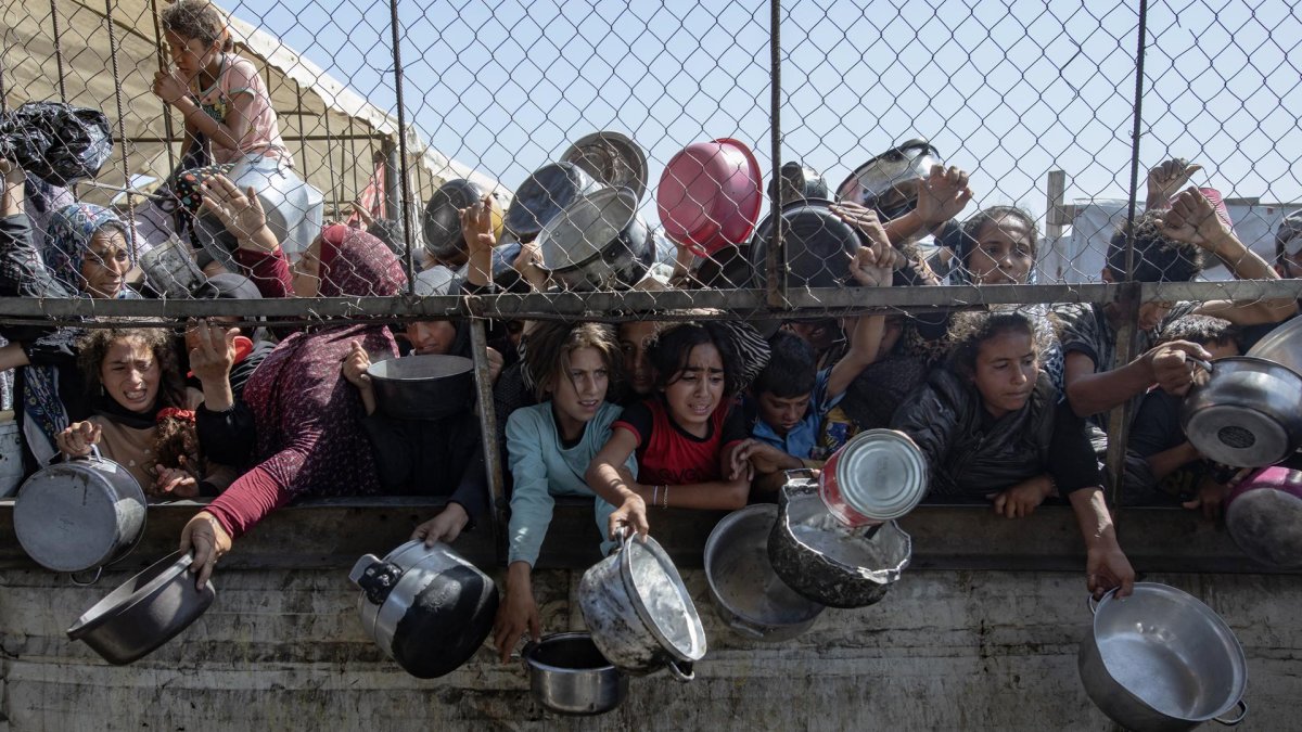 Palestinos desplazados se agolpan para recibir alimentos en Jan Yunis, en el sur de la Franja de Gaza.