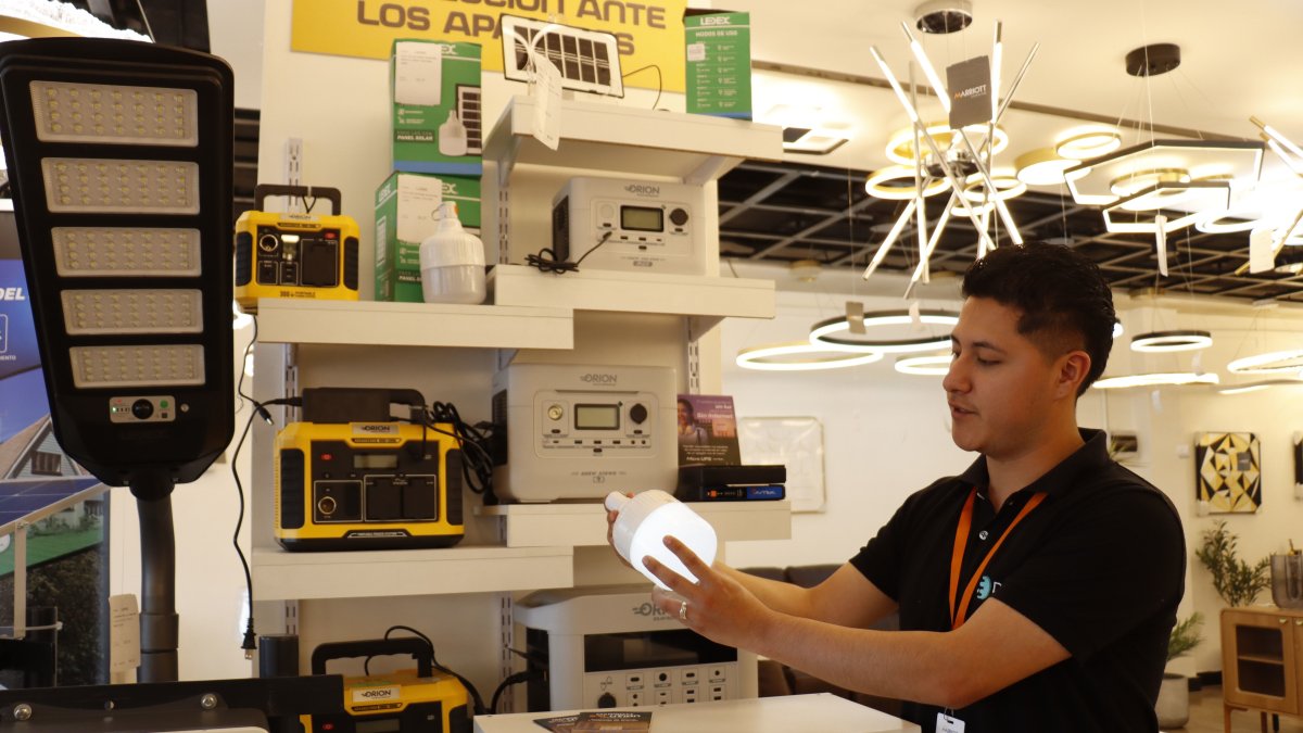 Almacén. Un ejecutivo de venta de una tienda en Quito muestra uno de los focos recargables que más se están vendiendo en estos días.
