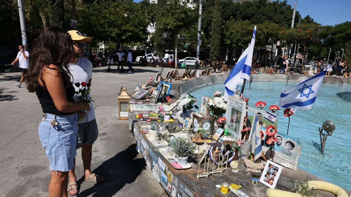 La gente lleva rosas para colocarlas en un monumento en Tel Aviv en memoria de los israelíes asesinados durante y en los dos años transcurridos desde los ataques de 2023.