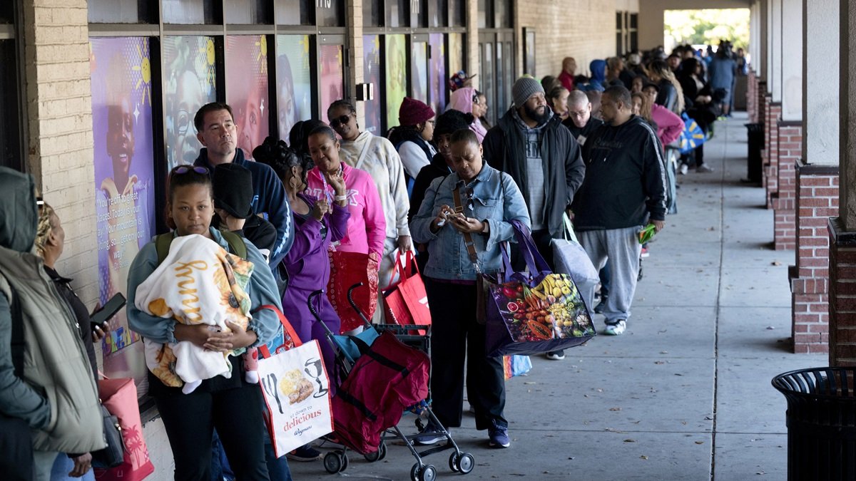 La gente hace fila para recibir alimentos para los trabajadores federales suspendidos en No Limits Outreach Ministries el 21 de octubre de 2025 en Hyattsville, Maryland.