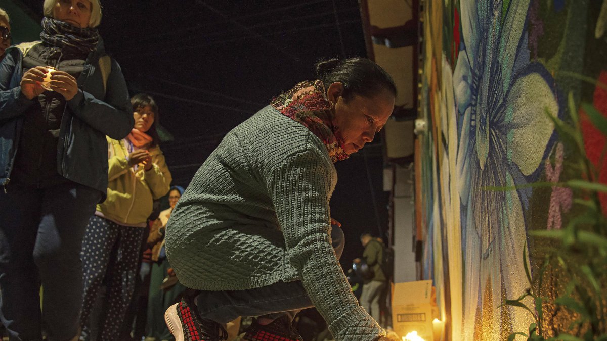 Una persona coloca una vela en un mural por la memoria del padre Marcelo Pérez este lunes, en San Cristóbal de las Casas (México).